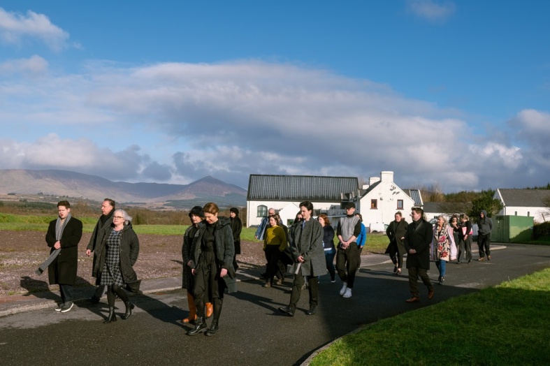 Taigh Ty Teach cast members lead the audience to the next performance venue. Photo Credit: Nathan Snow